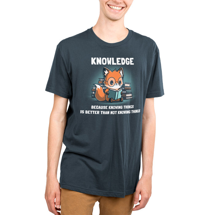 Premium Cotton T-shirt _TeeTurtle Knowing Things Denim Blue t-shirt featuring a fox wearing glasses, reading a book, with stacks of books behind it.