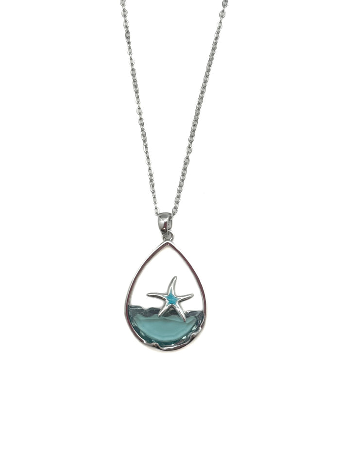 Teardrop-shaped pendant with starfish design on a white background