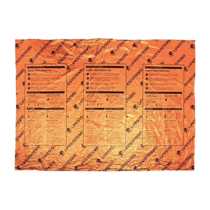 An orange Lifesystems heatshield thermal blanket with black printed instructions and the 'LIFESYSTEMS' brand name repeated across the surface, shown flat against a white background.