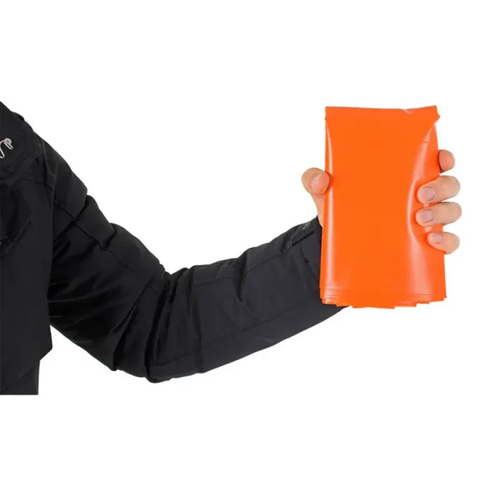 Person holding an orange Lifesystems Plastic Survival Bag against a white background