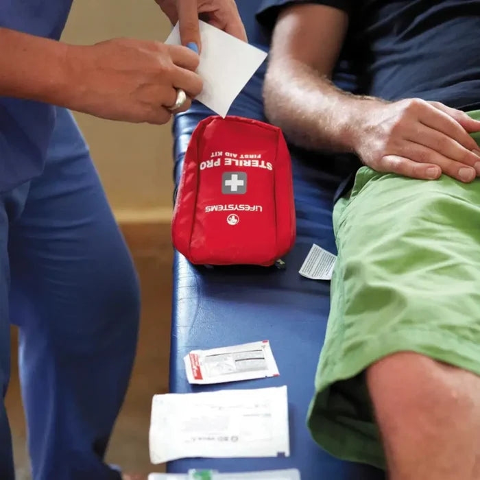 Lifesystems Sterile Pro First Aid Kit being used by a health professional to treat a patient