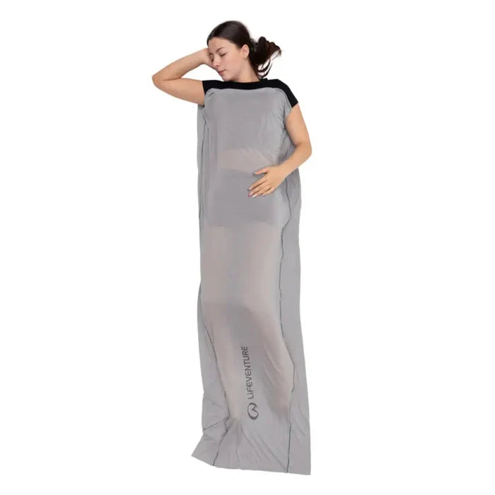 Woman asleep in a Lifeventure Cotton Sleeping Bag Liner Mummy on a white background