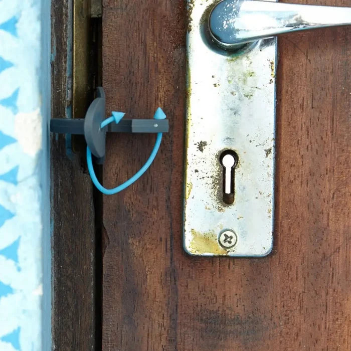Close-up of a wooden door with a Lifeventure travel door lock installed for extra security