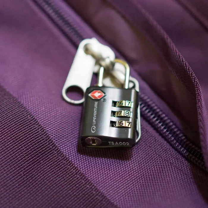 Lifeventure TSA 3 Dial Combination Padlock in black attached to the zips of a purple suitcase