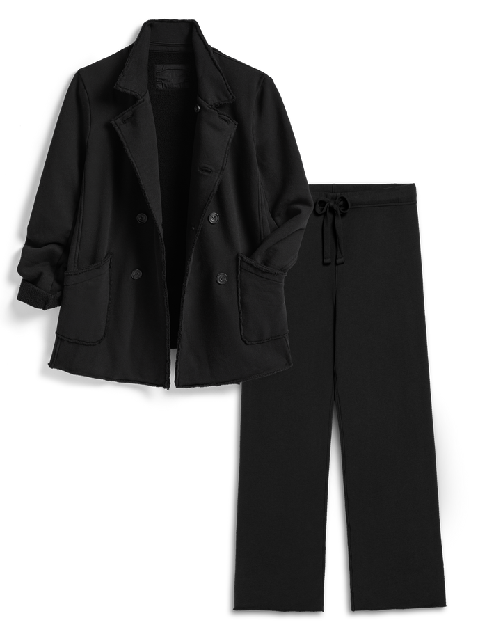 Black coat and pants set on a white background