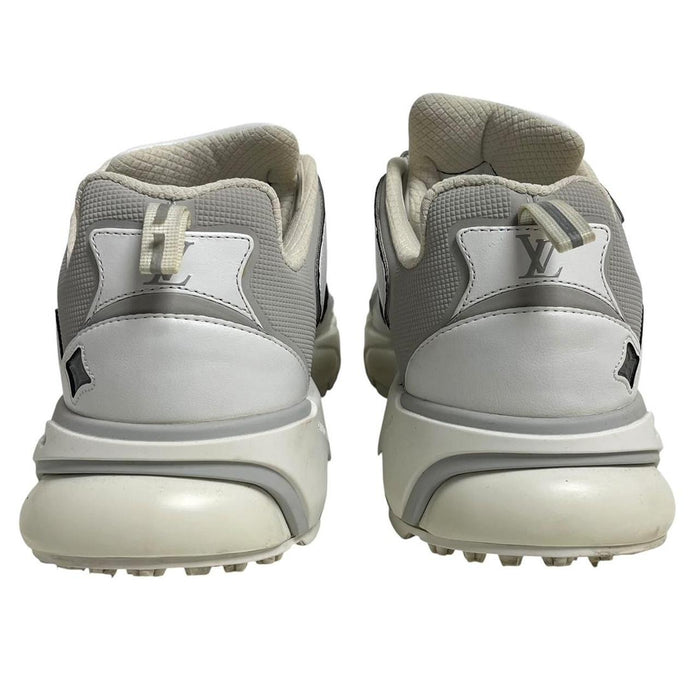 Louis Vuitton white trainers with logo detailing and sleek design, pre-owned condition.