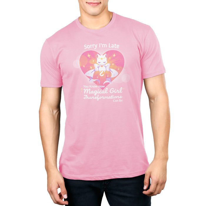 Premium Cotton T-shirt_TeeTurtle light pink Magical Girl Transformations apparel featuring a cat floating in a heart with a large bow and sparkles like classic anime girl. Captions says, "Sorry I'm late, you know how magical girl transformations can be".