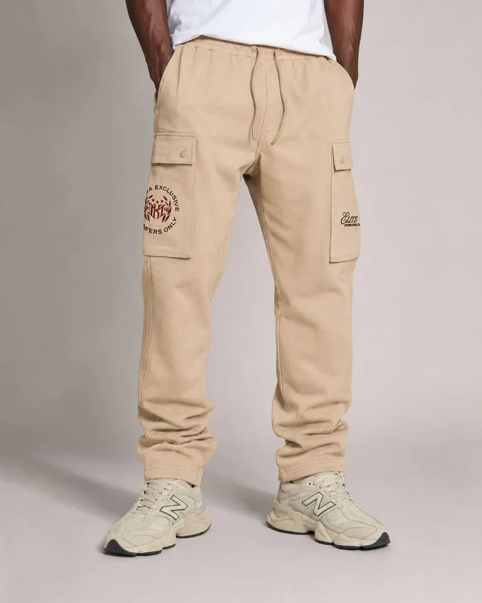 Makobi Elite Club stacked twill pants in khaki, featuring a relaxed fit and stylish design, displayed on a hanger.