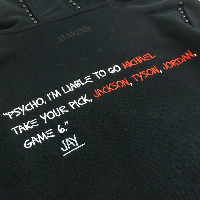 Black Makobi 'Icon' hoodie, casual hoodie with logo design, made by MAKOBI, displayed on a hanger.
