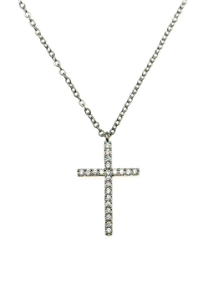 Pavé crystal cross pendant necklace on a silver chain against a white background