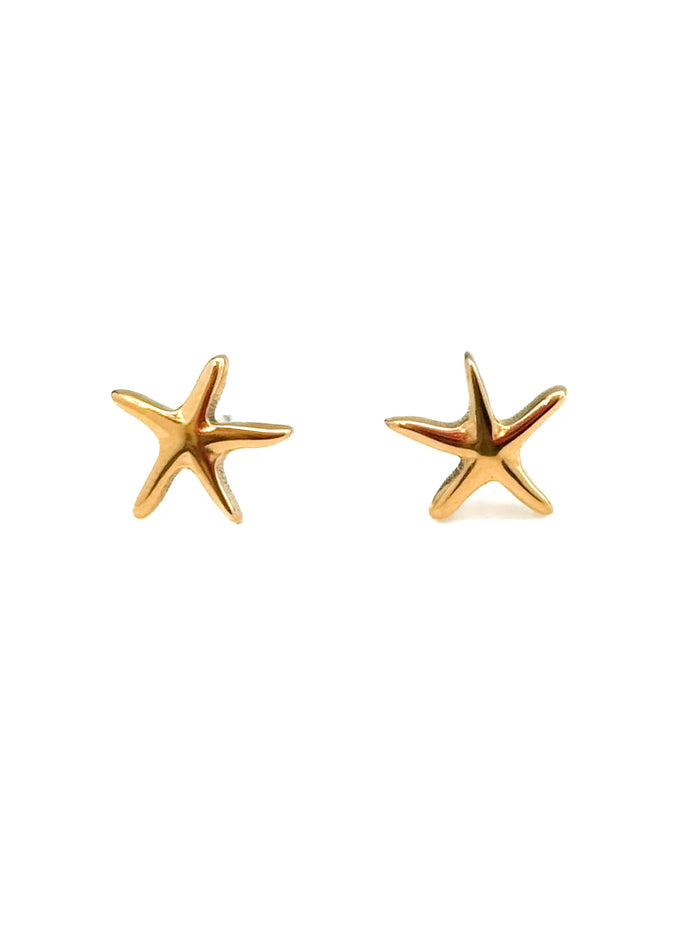 Gold starfish earrings on a white background
