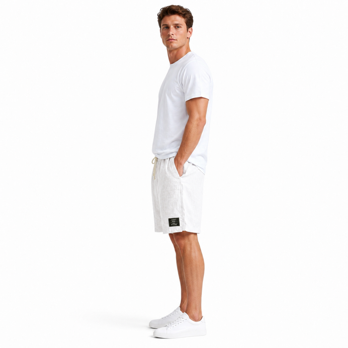 Men's summer linen shorts presented for casual beach outfits with a loose silhouette and subtle embroidered label detail now.