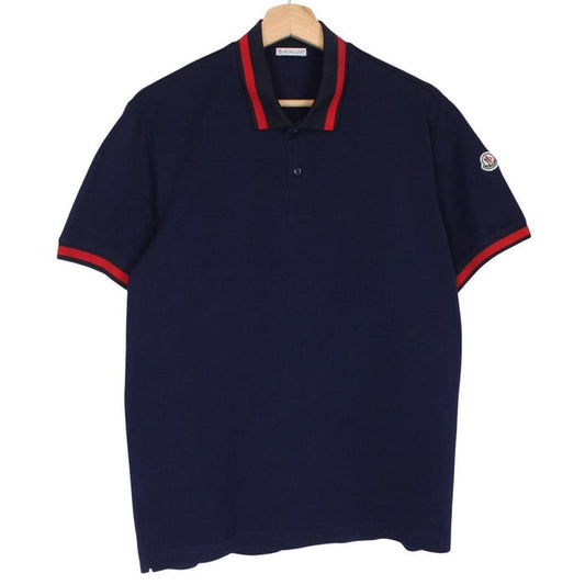 Moncler navy blue short sleeve polo shirt with embroidered logo and cotton material.