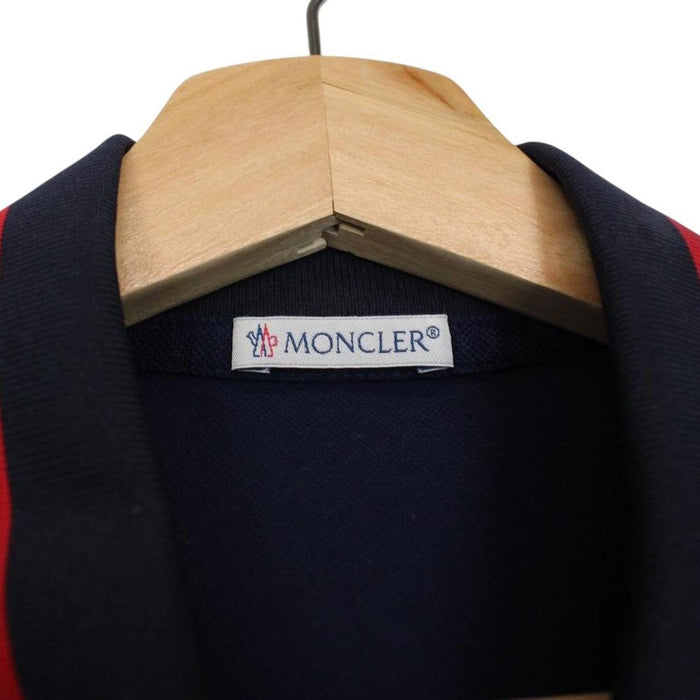 Moncler navy blue short sleeve polo shirt with embroidered logo and cotton material.