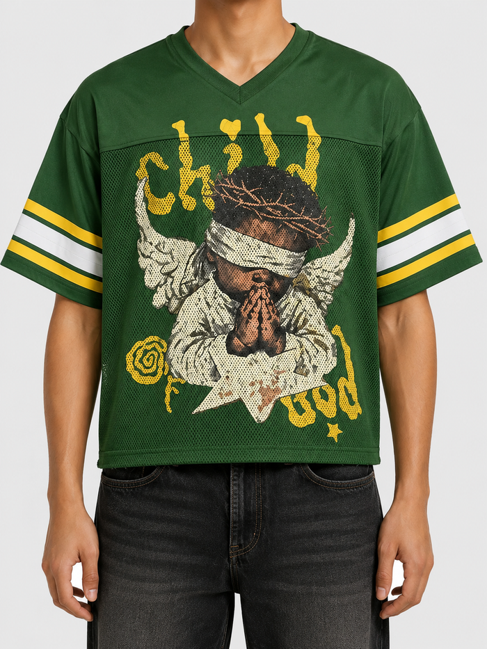Green Papercut Child Of God cropped jersey T-shirt shown on model, featuring a relaxed fit and casual style.