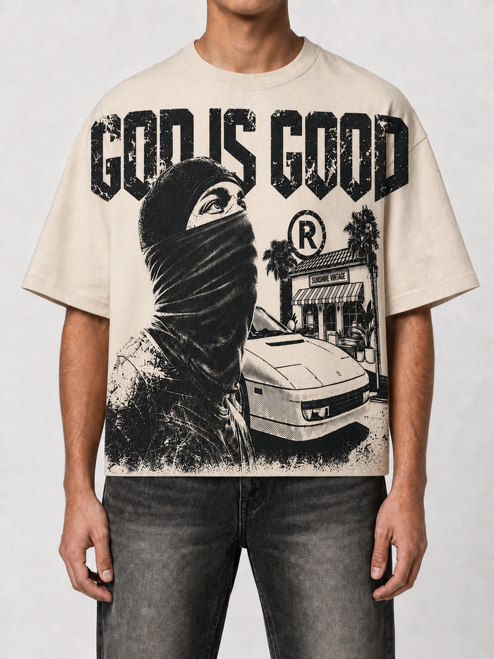 Cream oversized cropped T-shirt by PAPERCUT with "God is Good" graphic design, casual style, and relaxed fit.