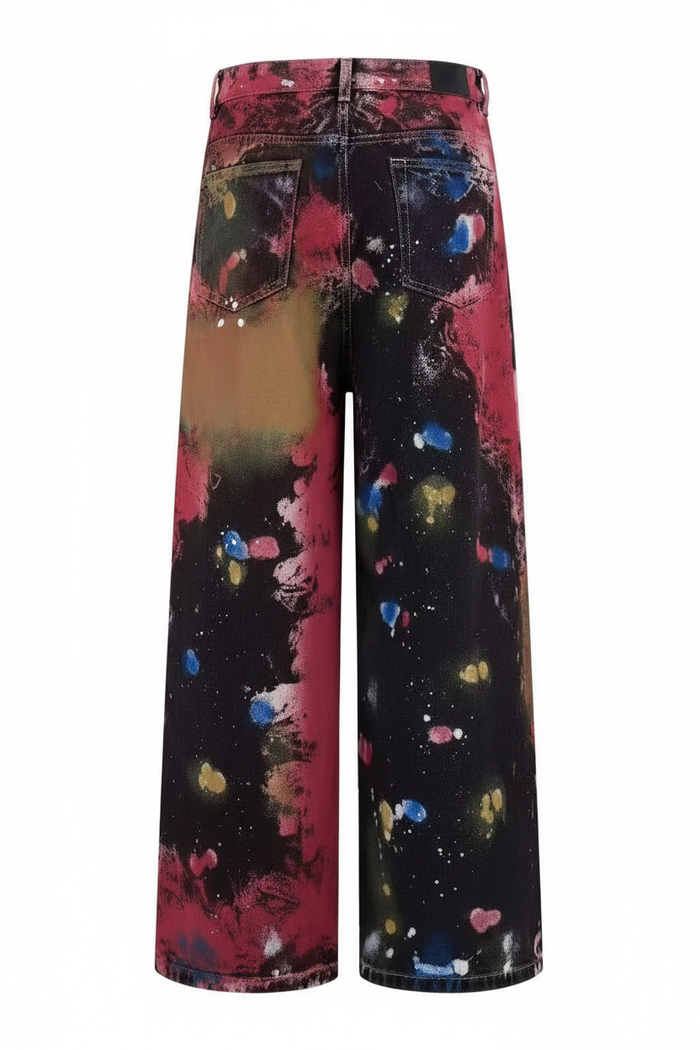 Picasso Jeans back view, wide-leg paint splatter denim on white studio background
