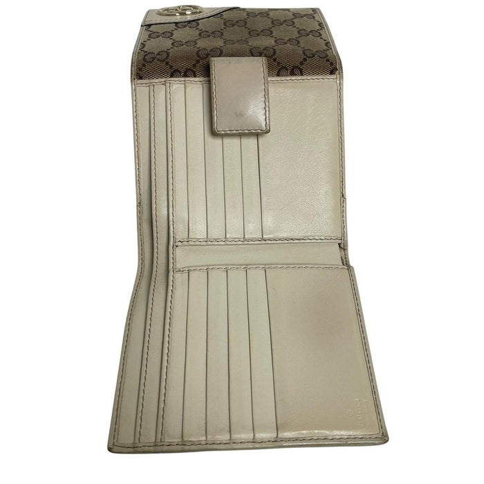 Gucci brown bifold wallet with Supreme monogram pattern and leather accents.