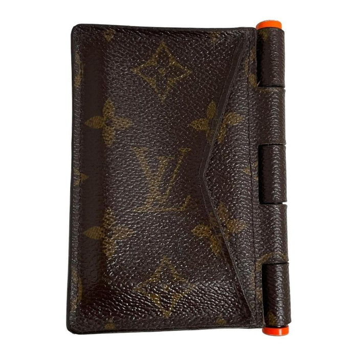 Louis Vuitton brown purse with orange metal hardware and iconic monogram pattern.