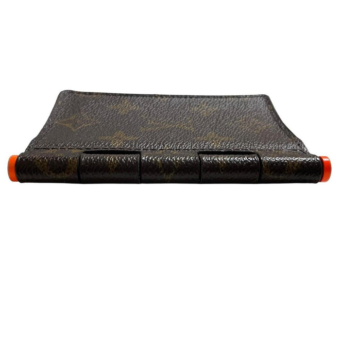 Louis Vuitton brown purse with orange metal hardware and iconic monogram pattern.