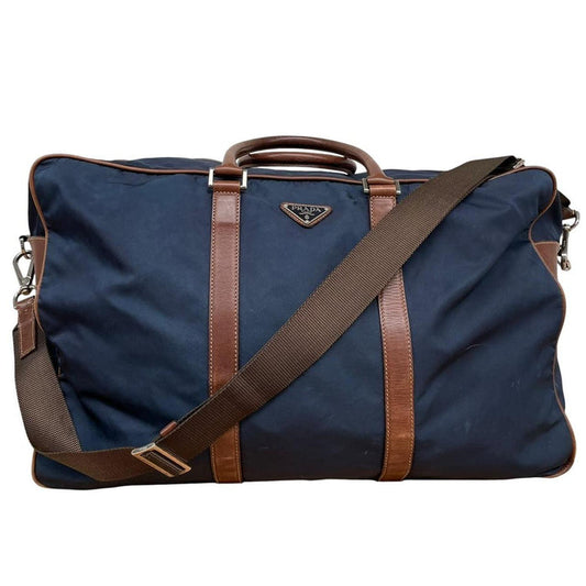 Prada navy blue and brown nylon duffel bag with signature logo and minimal wear.