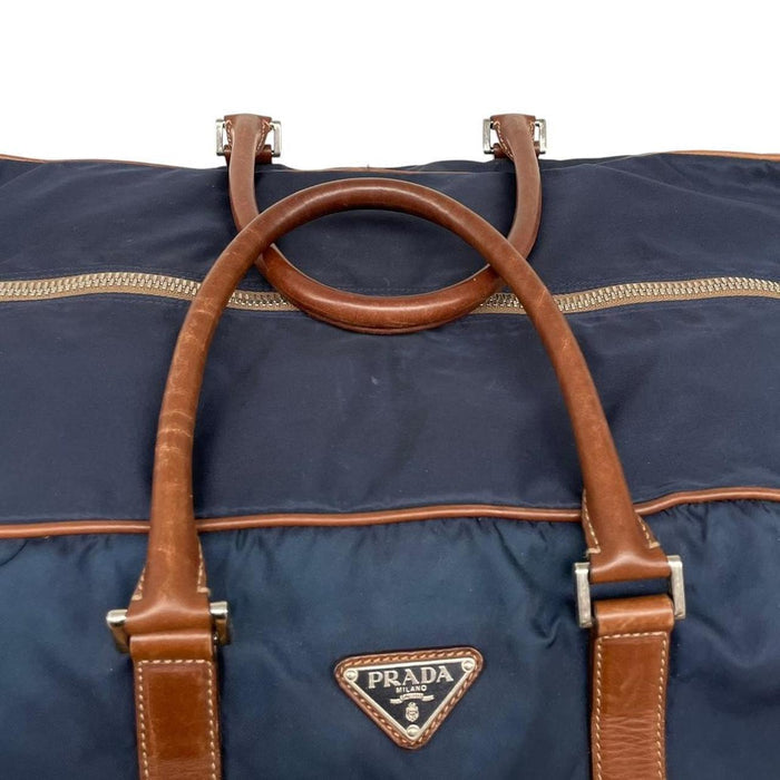 Prada navy blue and brown nylon duffel bag with signature logo and minimal wear.