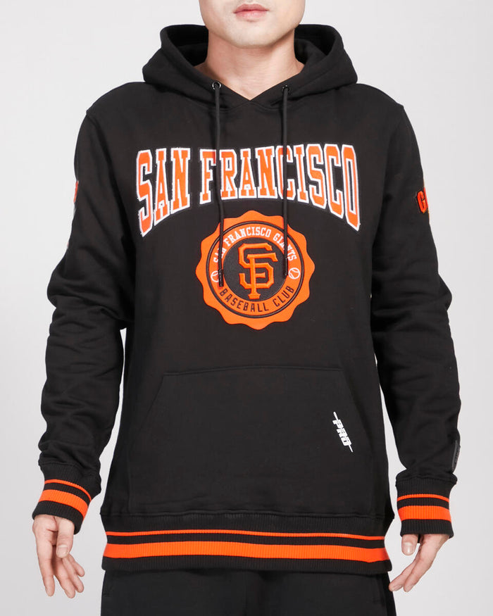 Pro Standard San Francisco Giants crest emblem hoodie featuring team logo embroidery on a black rib-knit hoodie.