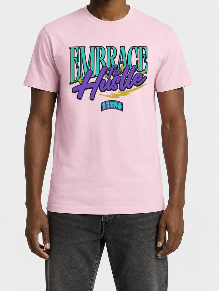 Pink R3TRO WORLD 'Embrace the Hustle' T-shirt with bold graphic design and casual fit, displayed on a neutral background.