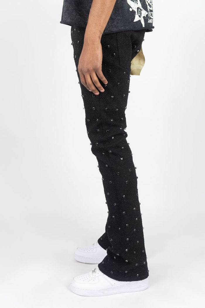Rebel Denim Diamond Stacked Flare Denim in black, featuring a fitted waist and dramatic flared legs with stacked detail.