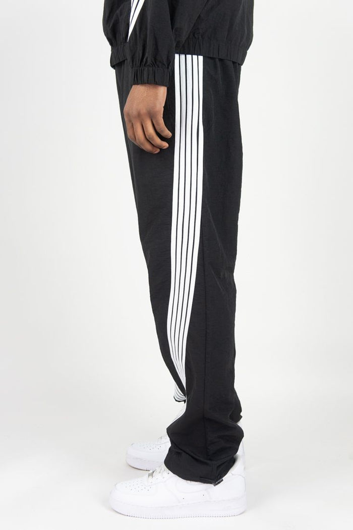 Rebel Minds black nylon sweatpants with bent stripe design, featuring a relaxed fit and elastic waistband.