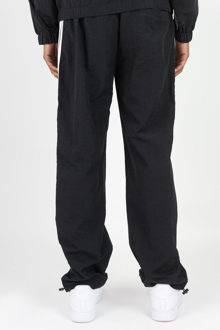 Rebel Minds black nylon sweatpants with bold striped design, comfortable fit, and elastic waistband for casual wear.