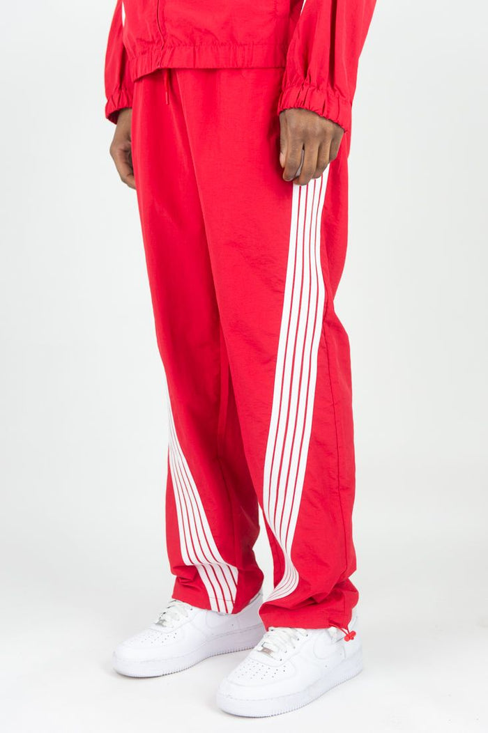 Rebel Minds Bent Stripes red nylon sweatpants with striped design and elastic waistband, casual athletic style.
