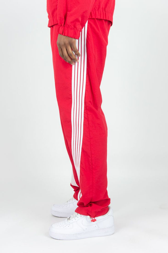 Rebel Minds Bent Stripes nylon sweatpants in red with black stripe detailing, comfortable athletic joggers for casual wear.