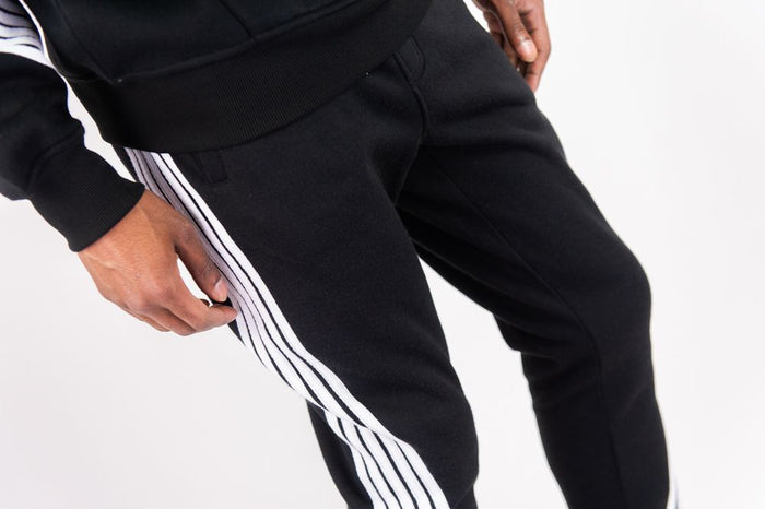 Rebel Minds Five Stripes black and white stacked sweatpants, casual fit, with striped design and elastic waistband.