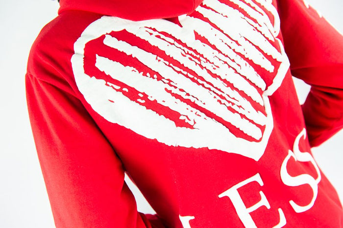 Red Rebel Minds 'Heartless' hoodie featuring a front graphic design, soft fabric, and adjustable drawstrings for casual wear.