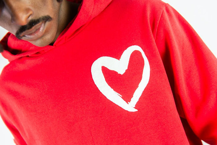 Red Rebel Minds 'Heartless' hoodie with front logo and drawstring hood, casual streetwear style.
