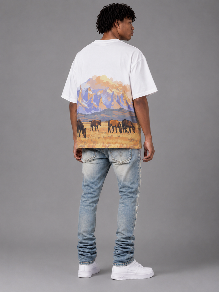 Red Letters "The Wild West" oversized white T-shirt featuring bold text design on the front.