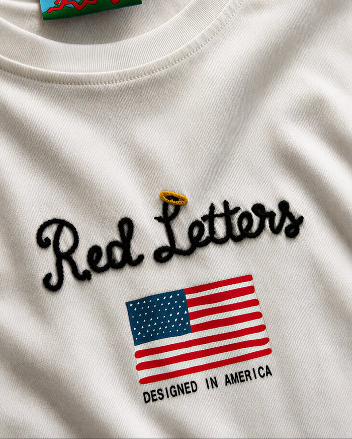 White Red Letters "The Wild West" oversized T-shirt featuring bold red text on the front.
