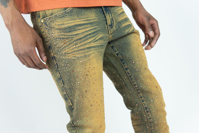 Roar Denim stacked flare jeans in rust with rhinestone details, showcasing a stylish denim look with a flared silhouette.