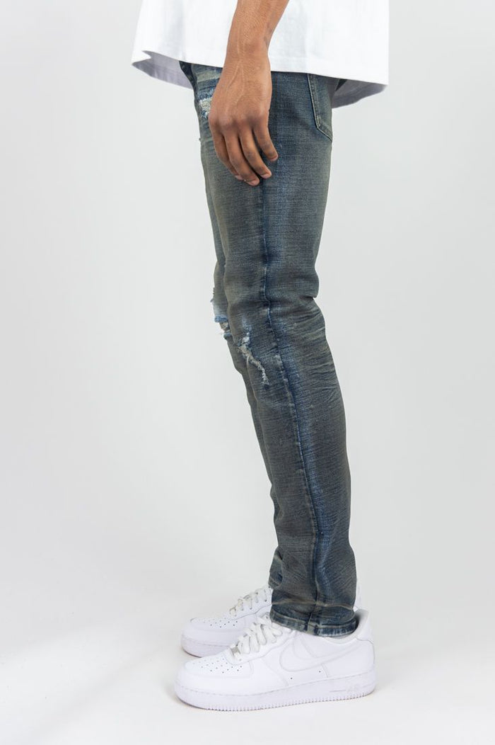 Dark vintage Roar Denim R&R slim straight denim jeans displayed on a hanger, showcasing their fit and fabric texture.
