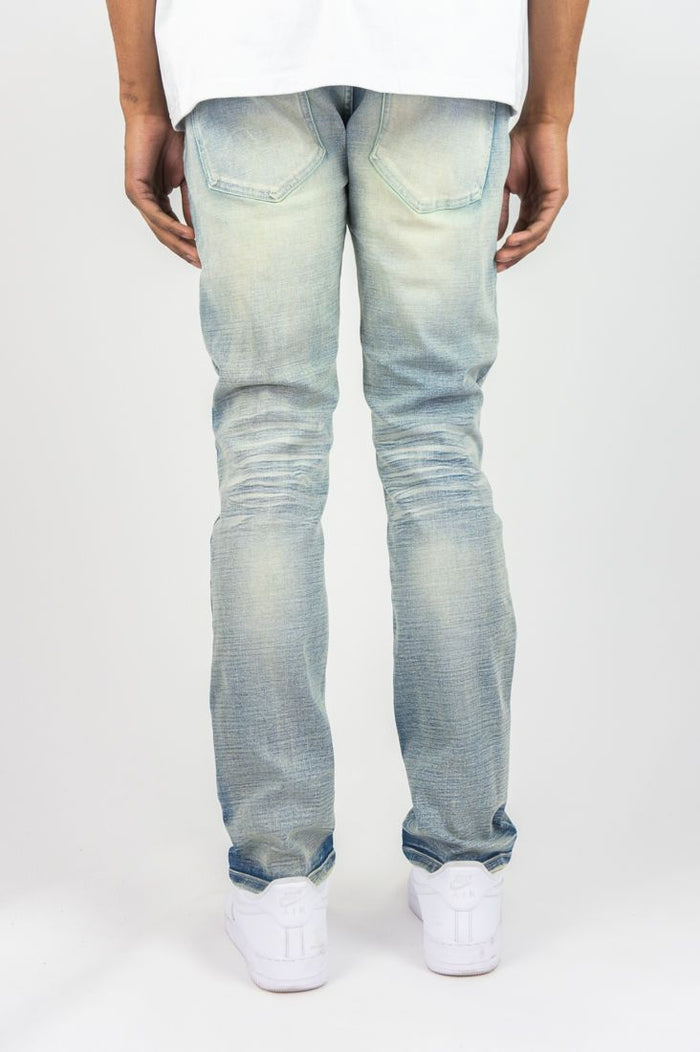 Roar Denim R&R slim straight denim jeans in light sand blue color, displayed on a hanger with visible stitching and classic denim styling.