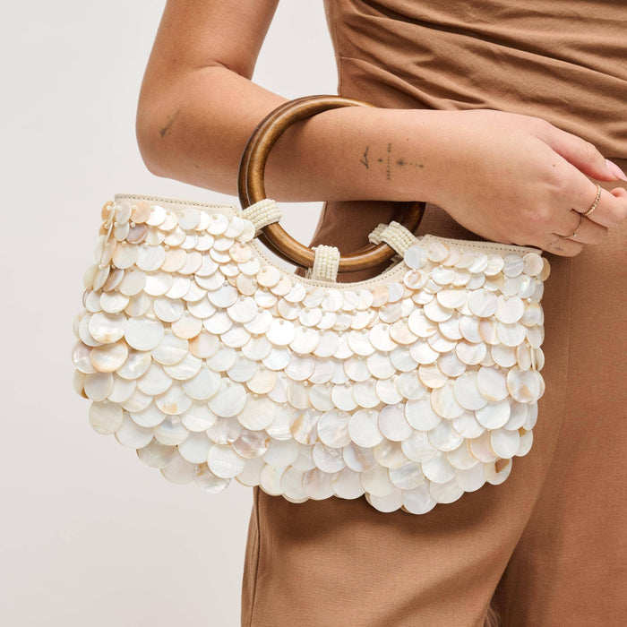 Scarlett Evening Bag featuring layered iridescent shell disc embellishments, polished round wood ring handles with beaded accents, and a removable gold-tone chain shoulder strap.