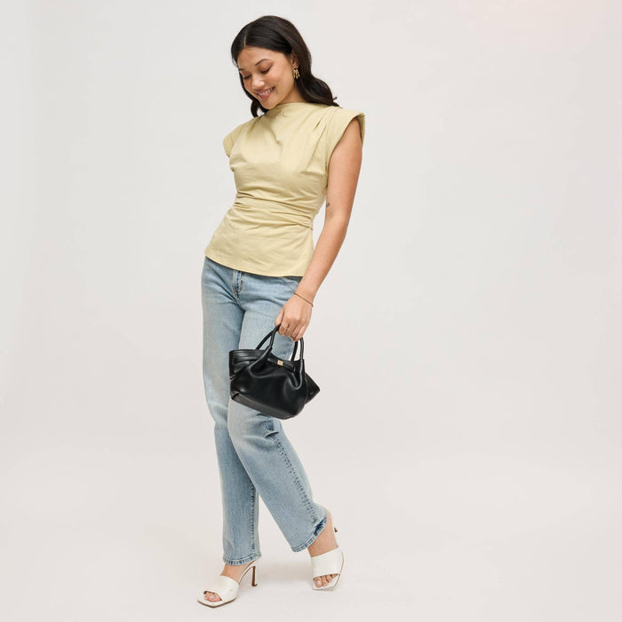 Model carrying the Selena Crossbody by its rolled top handles, featuring a softly gathered black vegan leather silhouette with polished gold-tone hardware.