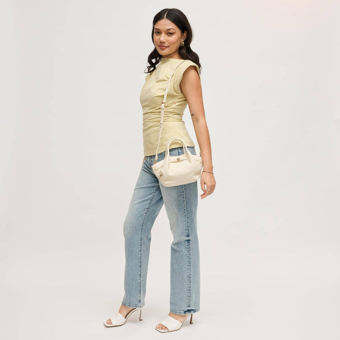 Model wearing the Selena Crossbody in cream with the adjustable shoulder strap, showcasing the soft-structured silhouette and versatile everyday design.