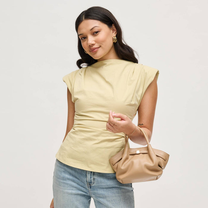 Model carrying the Selena Crossbody in taupe vegan leather, showcasing the soft gathered silhouette, rolled handles, and elegant gold-tone hardware.