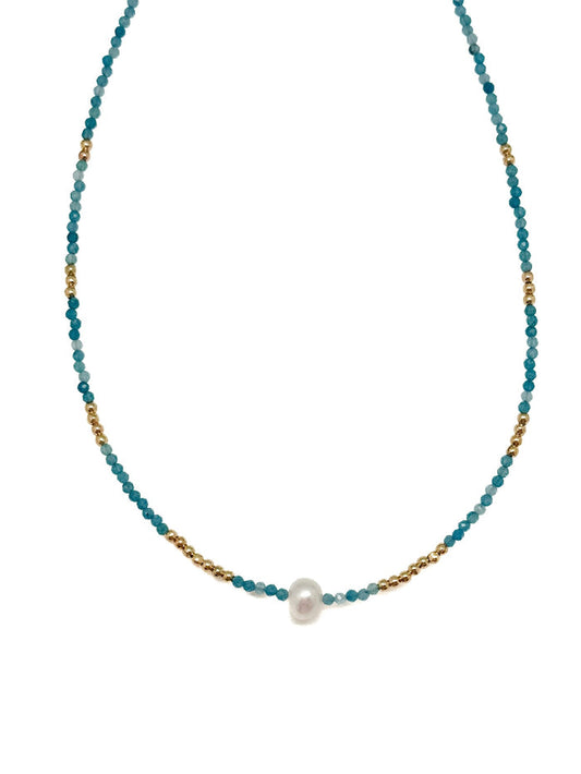 Sera Apatite Necklace with faceted blue apatite beads, gold accents, and a single center pearl on white background.