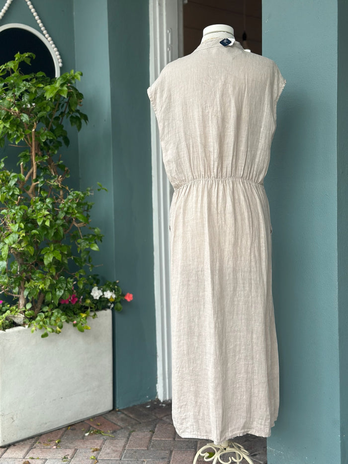 Back view of an oatmeal beige linen midi dress made in Italy with cap sleeves, an elasticized waist detail, and an easy, flowing fit.
