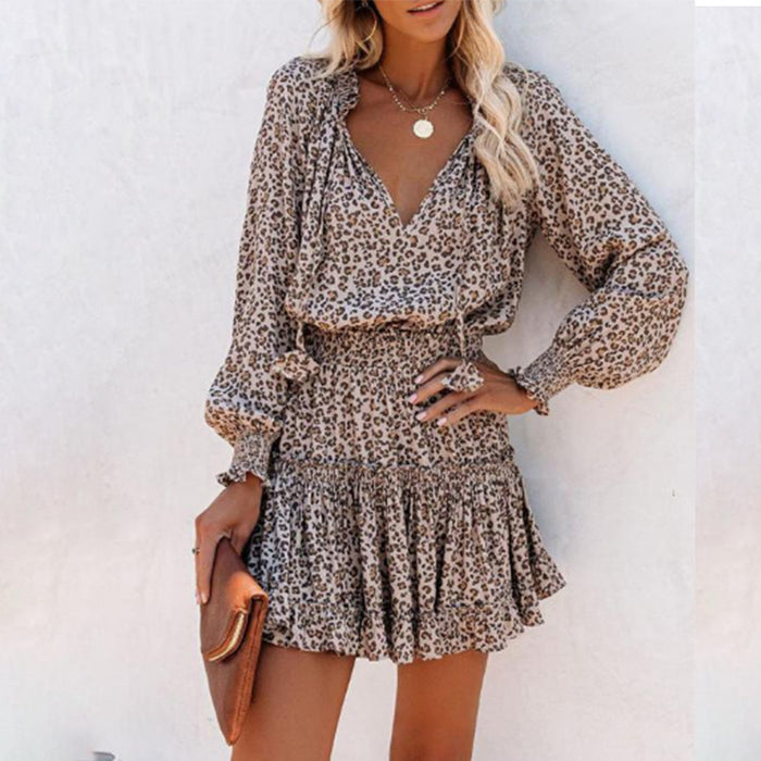 Women's printed mini dress in boho style, side-angle model pose, warm lighting