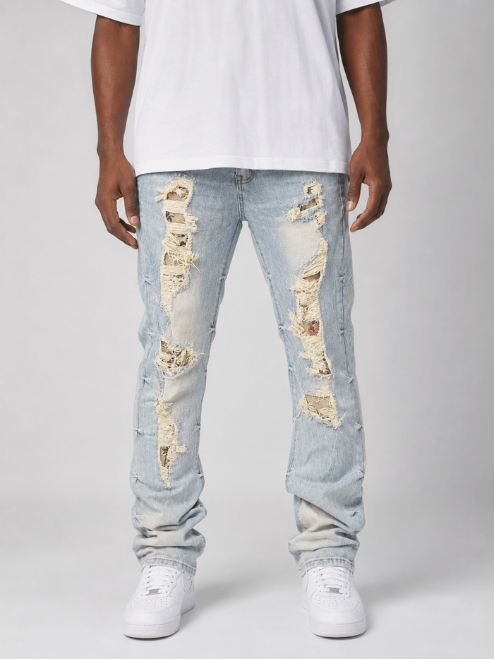 Smoke Rise Aim High tapestry applique stacked denim in Seville Blue, featuring detailed embroidery and textured denim fabric.