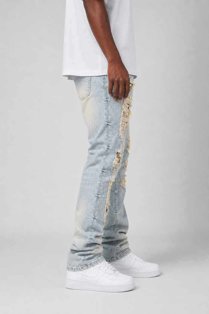 Smoke Rise Aim High tapestry applique denim stack in Seville Blue, featuring intricate embroidery on blue denim fabric.